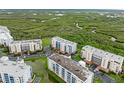 Overhead view of condos surrounded by lush green mangroves and waterways at 5300 S Atlantic Ave # 5507, New Smyrna Beach, FL 32169