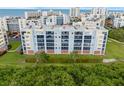Exterior aerial view of blue and white condo complex with balconies and landscaping at 5300 S Atlantic Ave # 5507, New Smyrna Beach, FL 32169