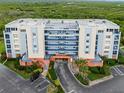 Aerial view of condo complex showing entryway, parking and landscaping at 5300 S Atlantic Ave # 5507, New Smyrna Beach, FL 32169