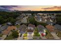 Aerial view of the community showcasing lush landscaping, mature trees, and multiple well-maintained single Gathering homes at 5672 Parkview Lake Dr, Orlando, FL 32821