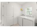 A bright and clean laundry room with a modern washer and dryer at 6834 Wilson Hammock Ave, Groveland, FL 34736
