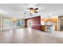 Bright and airy living room featuring neutral tile flooring and an open layout to the kitchen at 7249 Abbey Ln, Winter Park, FL 32792