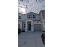 Welcoming townhome showing the facade, modern columns and neutral color scheme at 7612 Danube Rd, Kissimmee, FL 34746