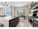 Modern kitchen featuring stainless steel appliances, quartz countertops, and a view to the dining area at 7740 Sandy Ridge Dr # 216, Reunion, FL 34747