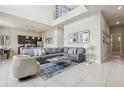 Bright, open-concept living room with soaring ceilings, modern decor, and a comfortable sectional sofa at 7740 Sandy Ridge Dr # 216, Reunion, FL 34747