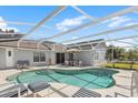 Inviting screened-in pool area with comfortable seating, perfect for relaxation and outdoor entertainment at 7760 Indian Ridge N Trl, Kissimmee, FL 34747