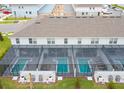 Aerial view of multiple private backyard pools within screened enclosures at 8944 Sydney Ave, Kissimmee, FL 34747