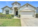Attractive single-Gathering residence with a two-car garage, and well-kept lawn with manicured bushes at 1061 Suffragatte Cir, Haines City, FL 33844