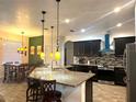 Stylish kitchen with granite countertops, stainless steel appliances, and modern hanging pendant lights at 1062 Rock Creek St, Apopka, FL 32712