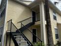 View of the side of the condo building with dark metal stairs at 1089 S Hiawassee Rd # 323, Orlando, FL 32835
