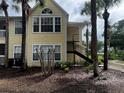 View of the side of the condo building with dark metal stairs at 1089 S Hiawassee Rd # 323, Orlando, FL 32835