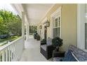 Inviting front porch with comfortable seating, charming columns, and stylish outdoor decor, creating a welcoming entrance at 1184 Fern Ave, Orlando, FL 32814