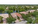 Stunning aerial view of homes with red tile roofs along the water, surrounded by lush greenery at 11863 Delfina Ln, Orlando, FL 32827