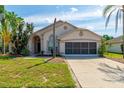 Welcoming single-Gathering home with a manicured lawn and an attached two-car garage at 131 Country Creek Ln, Kissimmee, FL 34746