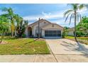 Inviting single-Gathering home featuring a well-kept lawn and a convenient two-car garage at 131 Country Creek Ln, Kissimmee, FL 34746