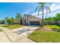 Charming single-Gathering home with a well-maintained lawn and a spacious driveway at 131 Country Creek Ln, Kissimmee, FL 34746