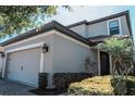 Angle view of two-story home showcasing white trim, grey siding, and desert landscaping at 1340 Blue Stem Ln, Winter Park, FL 32792