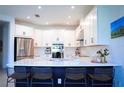 Open kitchen design with quartz countertops, stainless steel appliances, and bar seating at 1340 Blue Stem Ln, Winter Park, FL 32792