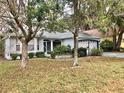 Inviting single-story home with well-maintained landscaping, gray driveway, and attached two-car garage at 144 Costa Mesa Dr, Lady Lake, FL 32159