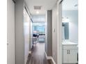 Hallway with wood floors leading to an open living area and bathroom at 150 E Robinson St # 626, Orlando, FL 32801