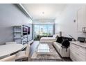 Modern condo living area with large windows, white furniture, and city views at 150 E Robinson St # 626, Orlando, FL 32801