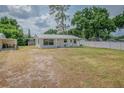 Well-maintained single-story home with white picket fence, providing privacy and curb appeal at 1505 W Lake Cannon Nw Dr, Winter Haven, FL 33881