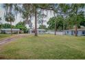 Lovely single-story home with a lush green lawn and mature trees providing shade and character at 1505 W Lake Cannon Nw Dr, Winter Haven, FL 33881