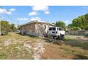 The back of the home features a cluttered yard with ladders, a work van, and an above-ground pool at 1508 Roger Babson Rd, Orlando, FL 32808