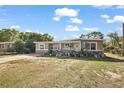 Charming single-story home featuring a cozy front porch and a well-maintained lawn with large driveway at 1508 Roger Babson Rd, Orlando, FL 32808