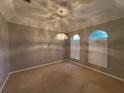 Inviting dining room with a trey ceiling and a decorative chandelier, offering a cozy atmosphere for dining at 151 Prestwick Dr, Davenport, FL 33897