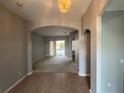 Open-concept living room with tile flooring, neutral paint, and a sliding door to the backyard at 151 Prestwick Dr, Davenport, FL 33897