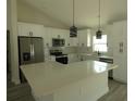 Bright, eat-in kitchen featuring white cabinets, stainless steel appliances, and pantry at 16648 Sw 25Th Ct, Ocala, FL 34473