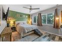 Cozy bedroom with custom green accent wall, contemporary furnishings and ample natural light at 170 Lago Vista Blvd, Casselberry, FL 32707