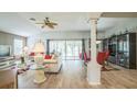 Bright living space showcasing a ceiling fan and seamless flow to the dining area at 17567 Se 81St Parnassus Ct, The Villages, FL 32162
