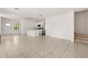 Open-concept living space with tile floors, white walls, and stainless steel appliances at 1797 Red Canyon Dr, Kissimmee, FL 34744