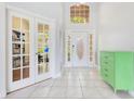 Bright foyer features tile flooring and access to the office at 1837 Sweetwater West Cir, Apopka, FL 32712