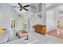 Spacious living room with large windows and staircase at 1837 Sweetwater West Cir, Apopka, FL 32712
