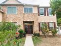 Charming home with brick facade, complemented by well-maintained landscaping and double-door entrance at 211 Hunt St, Clermont, FL 34711