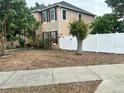Home exterior showcasing white fence and lush green yard, highlighting privacy and outdoor space at 211 Hunt St, Clermont, FL 34711