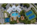 Aerial view showcasing a pool, tennis courts, a basketball court, playground, and community gathering spaces at 2304 Silver Palm Dr # 304, Kissimmee, FL 34747