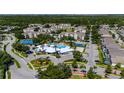 Stunning aerial view of a community featuring a large pool, clubhouse, tennis courts, and beautiful landscaping at 2304 Silver Palm Dr # 304, Kissimmee, FL 34747