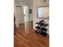 Hallway showcasing wood floors, decorative accents, and doorways leading to various rooms in the home at 2882 Club Cortile Cir # B, Kissimmee, FL 34746