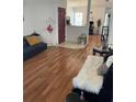 Inviting living room with hardwood floors, a stylish black sofa, and a cozy faux fur throw at 2882 Club Cortile Cir # B, Kissimmee, FL 34746