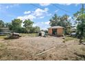 Large backyard featuring storage shed, trampoline, and grill area provides ample space for outdoor activities and entertainment at 2921 Bon Air Dr, Orlando, FL 32818