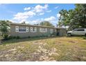 Inviting single-story house with decorative shutters, a tidy front yard, and easy parking access for comfortable, convenient living at 2921 Bon Air Dr, Orlando, FL 32818