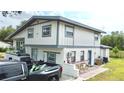 Rear exterior view featuring a split level home with a white and grey color scheme at 2932 Larson St, Kissimmee, FL 34741