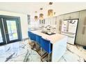 Modern kitchen featuring a large island, sleek countertops, and stainless steel appliances at 2932 Larson St, Kissimmee, FL 34741