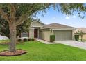Charming home with mature landscaping, manicured lawn and covered front entryway at 2950 Inca Ave, Clermont, FL 34715