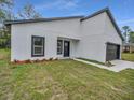 New construction home featuring dark trim, a simple landscaping design, and freshly cut lawn at 357 Marion Oaks Pass, Ocala, FL 34473