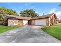 View of the driveway leading to a single Gathering home with a spacious garage at 4265 Old Colony Rd, Mulberry, FL 33860